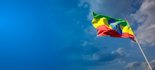 Beautiful national state flag of Ethiopia with blank space. Ethiopia flag on wide background with place for text 3D artwork.