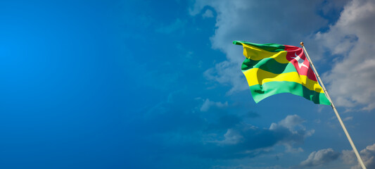 Beautiful national state flag of Togo with blank space. Togo flag on wide background with place for text 3D artwork.