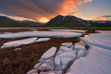 Ice on a stream in the tundra in the valley of the mountains