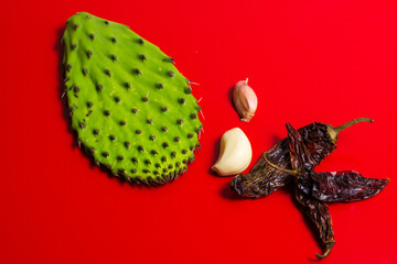 Composition with nopal, garlic and three dried red chili peppers.