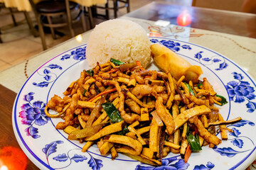 Close up shot of Chinese style fried pork slice with tofu and rice