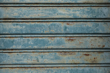 old and weathered metal plate or window,, blue painted metal jalousie,  perfect for a background with text or a gift card