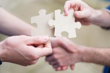 Cooperation, partnership and handshake teamwork in business group. Business puzzle concept. - 392186810