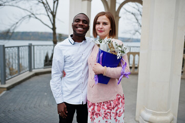Happy multiethnic couple in love story. Relationships of african man and white european woman.
