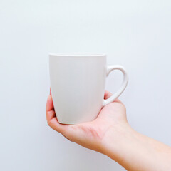 hand holding a cup
