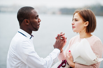 Happy multiethnic couple in love story. Relationships of african man and white european woman.