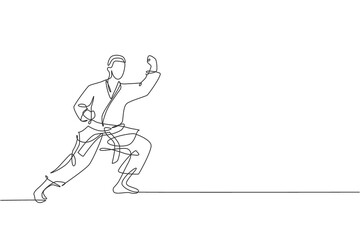 Single continuous line drawing of young confident karateka man in kimono practicing karate combat at dojo. Martial art sport training concept. Trendy one line draw design graphic vector illustration