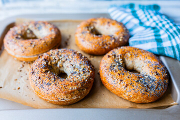 Fresh and crispy homemade bagels with sesame and poppy seeds.