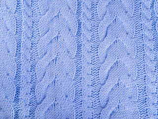 Beautiful wool knitted background with pattern in pale blue color.