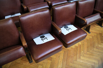 Theatre and concert chairs marked becouse of corona virus distance covid19