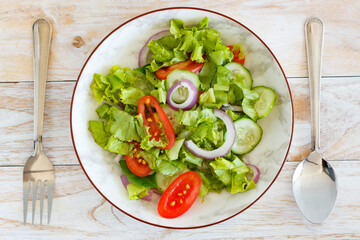 Green salad on the wooden table