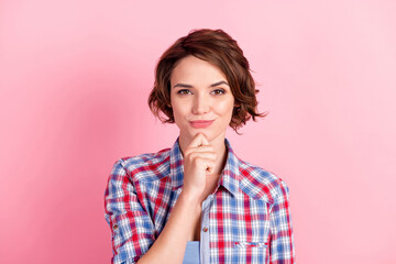 Photo portrait of curious girl touching face chin with finger isolated on pastel pink colored background