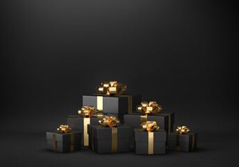 Black gift boxes with golden ribbon on black background