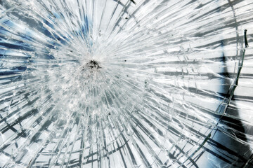 Intensive broken glass, big hole, from rock or bullet.