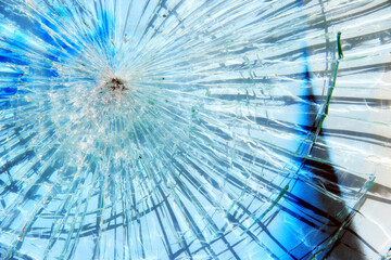 Intensive broken glass, big hole, from rock or bullet.