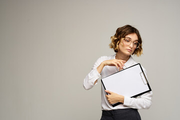 Naklejka premium Business woman with folder of documents in hands on gray background cropped view of work