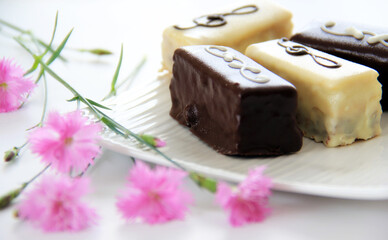 Chocolate, biscuits, desert on a white plate.