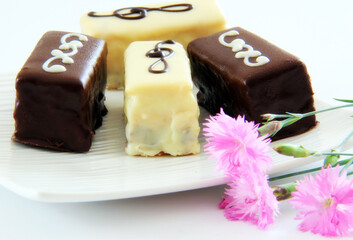 Chocolate, biscuits, desert on a white plate.