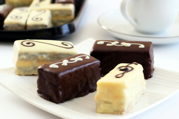 Chocolate, biscuits, desert on a white plate.