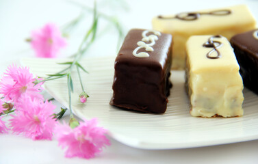 Chocolate, biscuits, desert on a white plate.