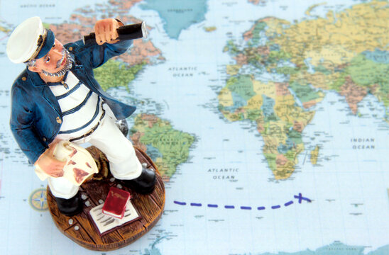 Small sailor on a world map, traveling cross the ocean with path set.
