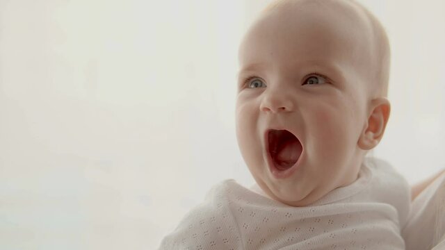 Surprised child watching all around, opening mouth in excitement, delight