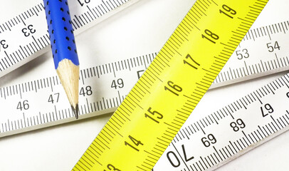 Meter and pen on a white paper, prepared for workingon a new plan.