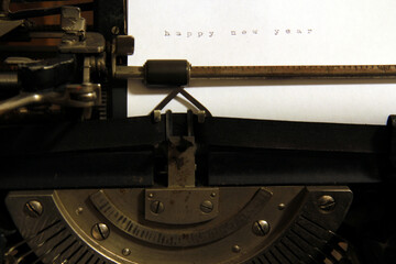 Happy New Year on white paper, old typewriter.