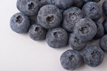 Berry background. Fresh berry blueberries on a white background. Concept of healthy and diet food. Flat lay, top view, Ripe blueberries with copy space for text, shallow DOF