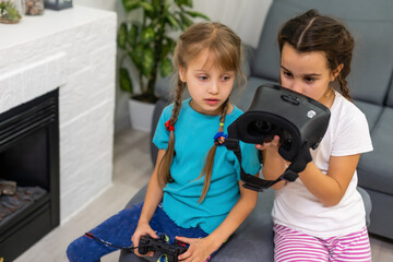 two little girls using glasses of virtual reality headset. concept of modern technologies