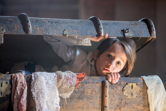 Little Child, Boy, Hiding In Old Vintage Suitcase In The Attic