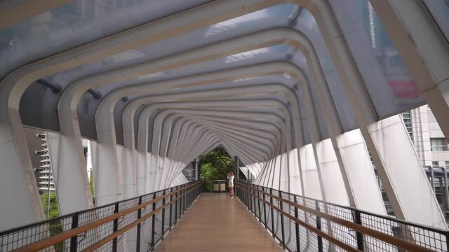 day time jakarta city center famous pedestrian bridge slow motion walking panorama 4k indonesia