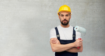 profession, construction and building concept - male worker or builder in yellow helmet and overall...