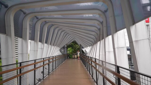 day time jakarta city center famous pedestrian bridge slow motion walking panorama 4k indonesia