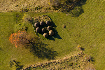 Group of autumn haystacks in a meadow, aerial view