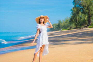 Portrait beautiful young asian woman relax smile leisure around sea beach ocean