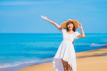 Fototapeta na wymiar Portrait beautiful young asian woman relax smile leisure around sea beach ocean