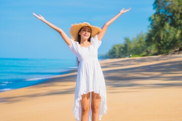 Portrait beautiful young asian woman relax smile leisure around sea beach ocean - 392204878