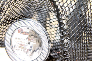 Black bicycle basket with a light in the park.