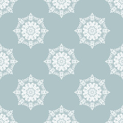 Floral vector ornament. Seamless abstract classic background with flowers. Pattern with repeating blue and white floral elements. Ornament for fabric, wallpaper and packaging