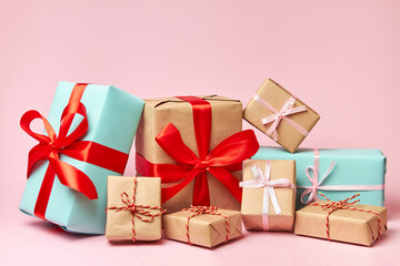 Christmas or New Year gift boxes against a pink background. Close-up, selective focus