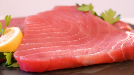 fresh and raw red tuna fillet on wooden board