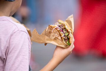 Anonymous child with delicious burger
