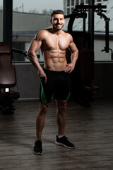 Fototapeta na wymiar Serious Bodybuilder Standing in the Gym