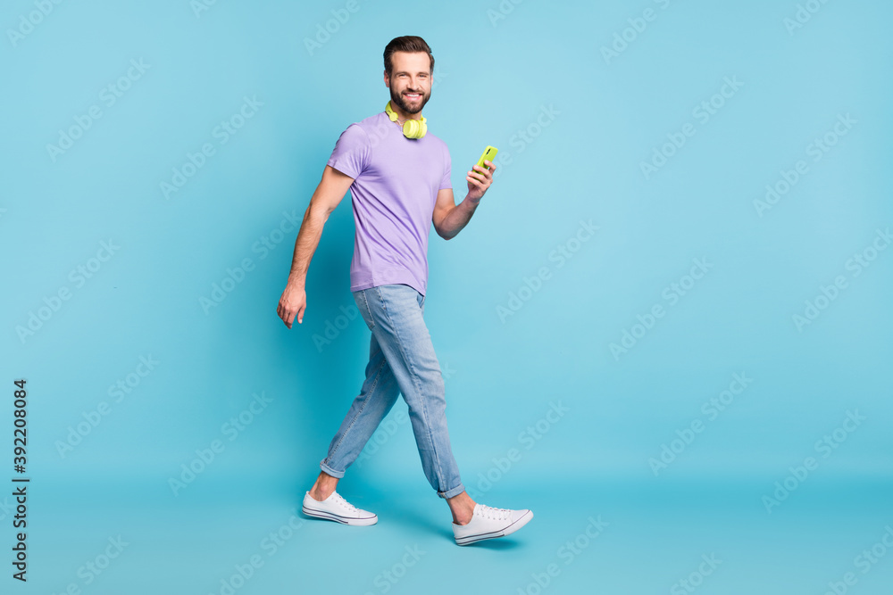 Sticker full length body size photo of hipster wearing casual clothes headphones keeping smartphone isolated