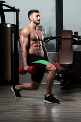 Plakat Man Athlete Exercising Glutes With Dumbbell