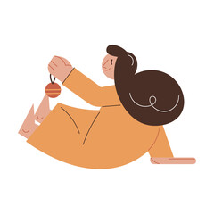 Happy young girl sitting and playing with golden decorative ball for Christmas tree