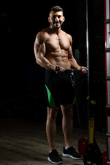Obraz na płótnie Canvas Man Exercising Biceps In The Gym