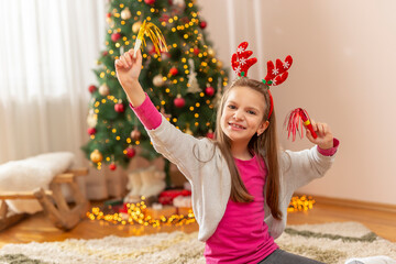 Kid playing with party whistles on Christmas day