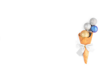 Christmas tree colored balls in a waffle cone on a white background.